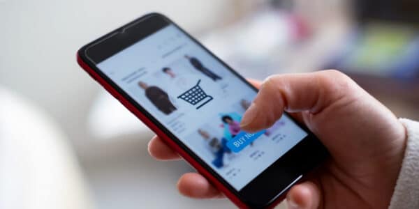 Close up of person shopping on a mobile phone: Digital Future of eCommerce