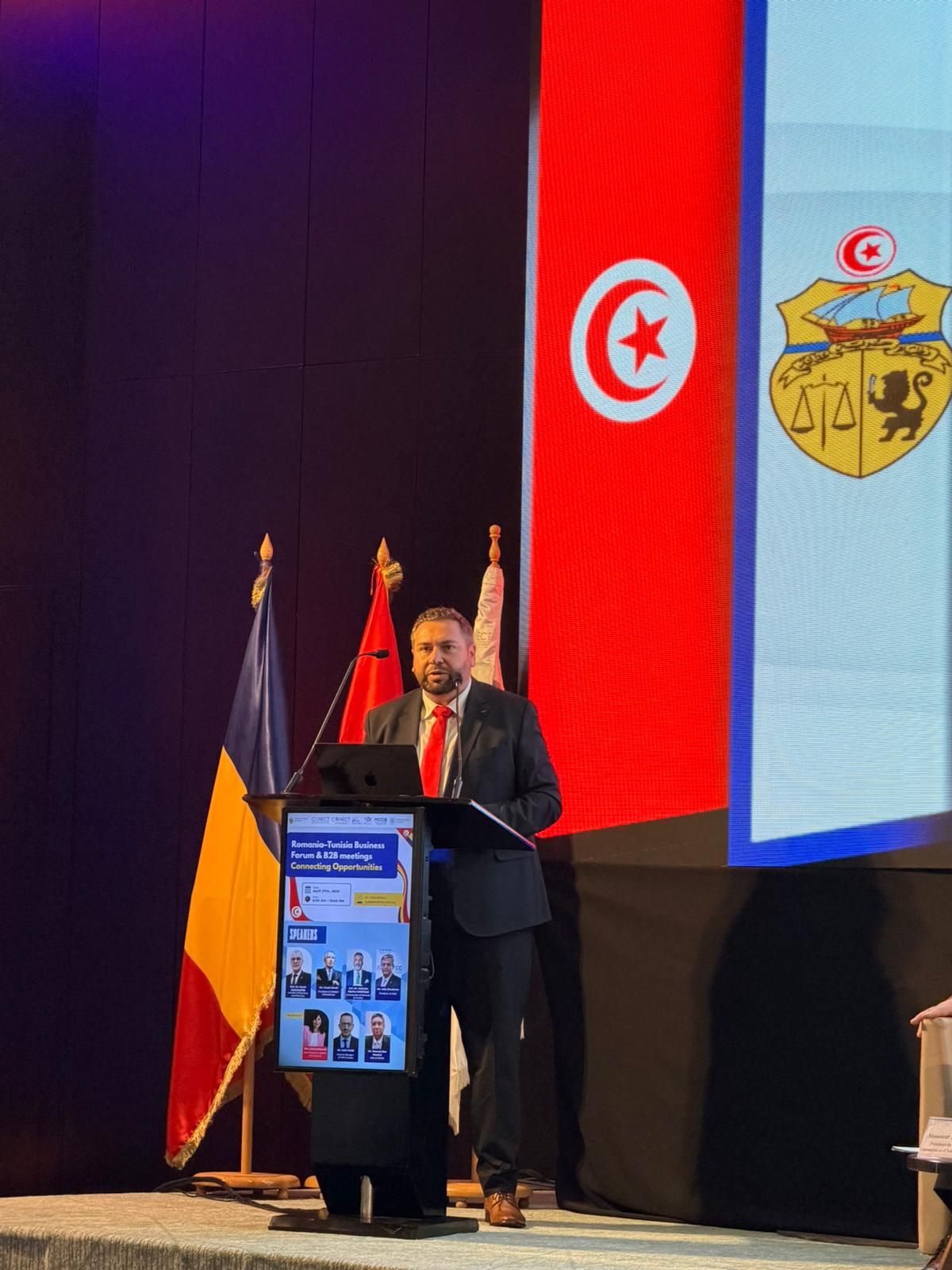 Bogdan at Podium with Tunisian Flag behind him